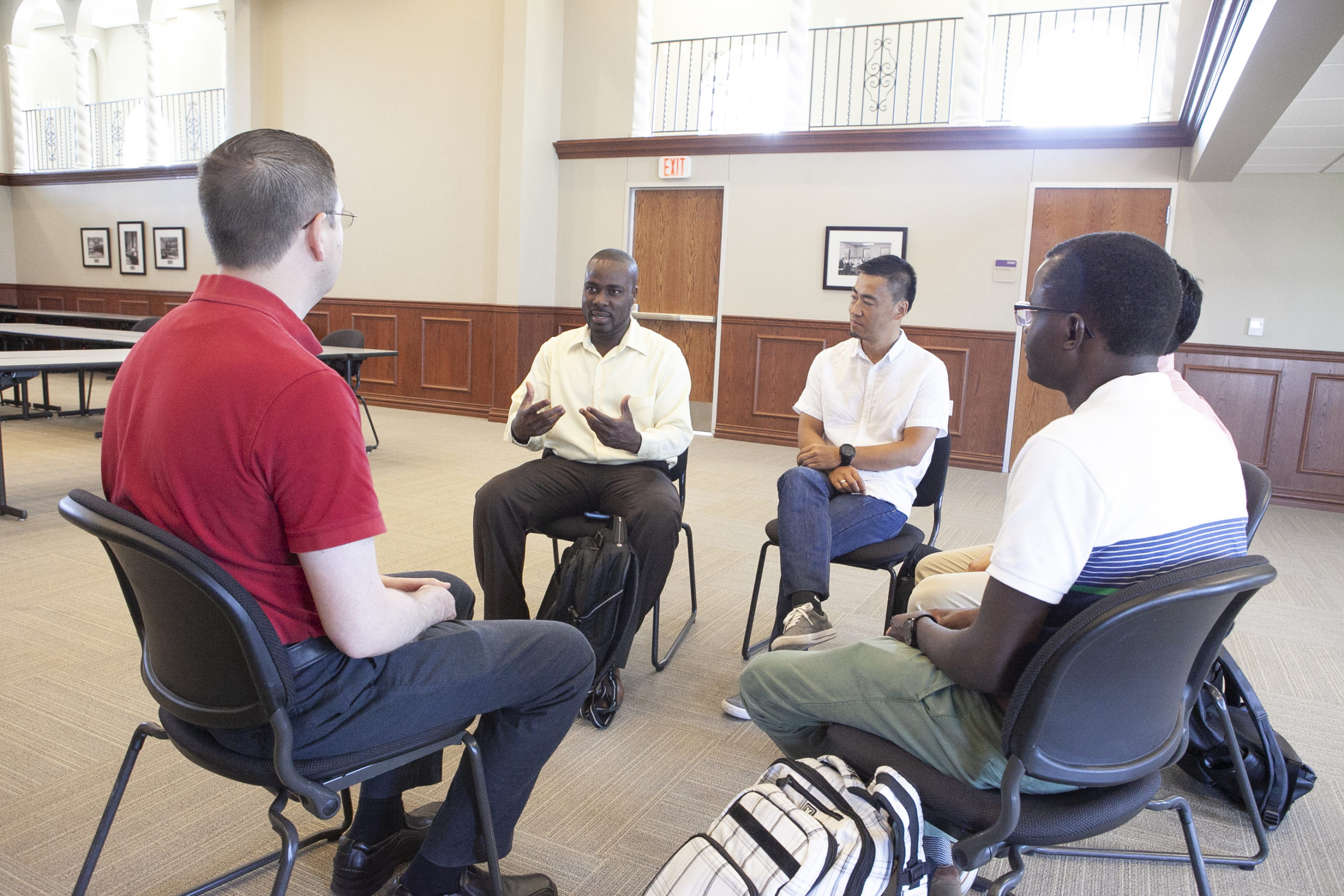 group of men sitting in a circle