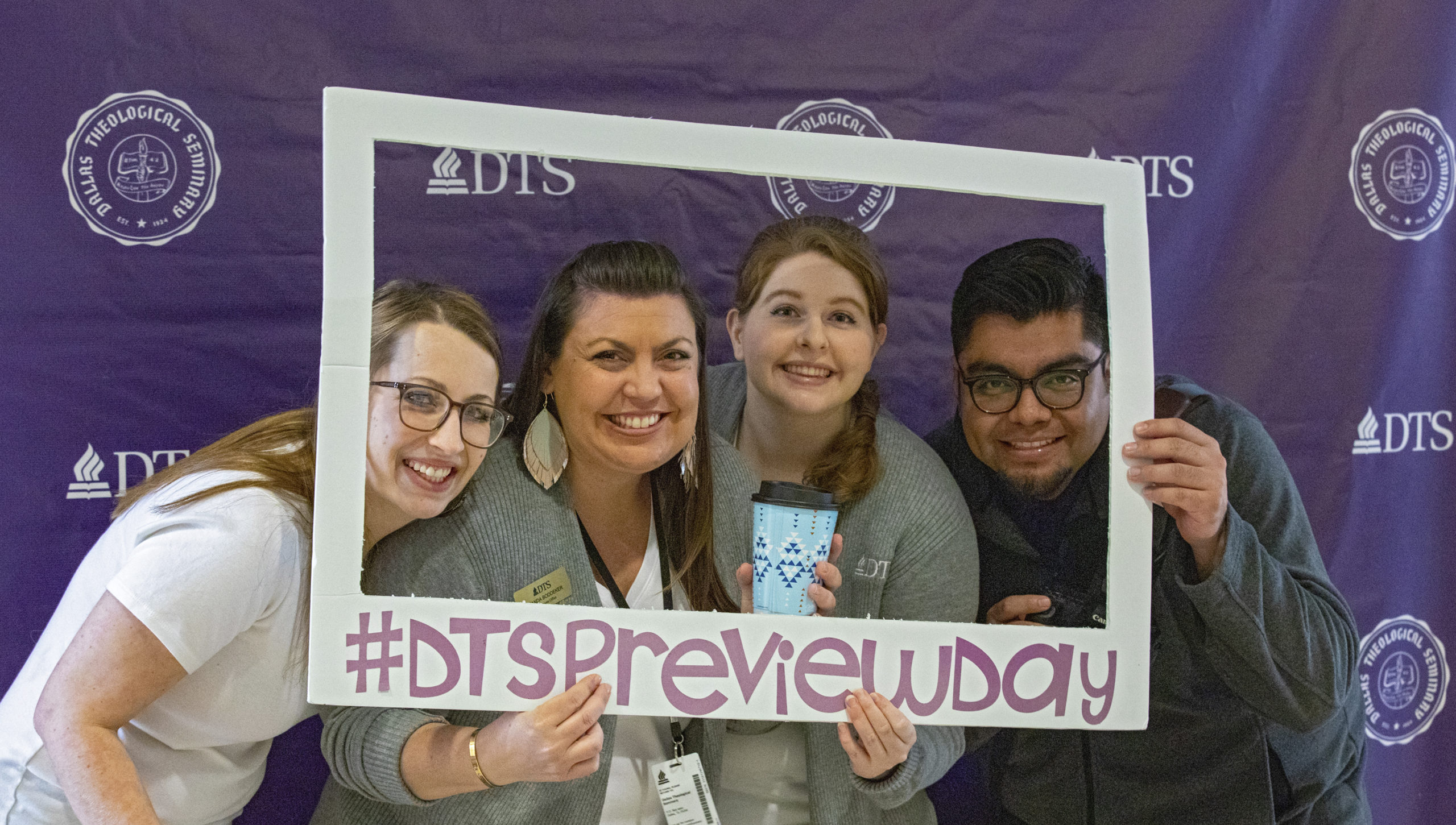 four people hold a sign that says DTS preview day