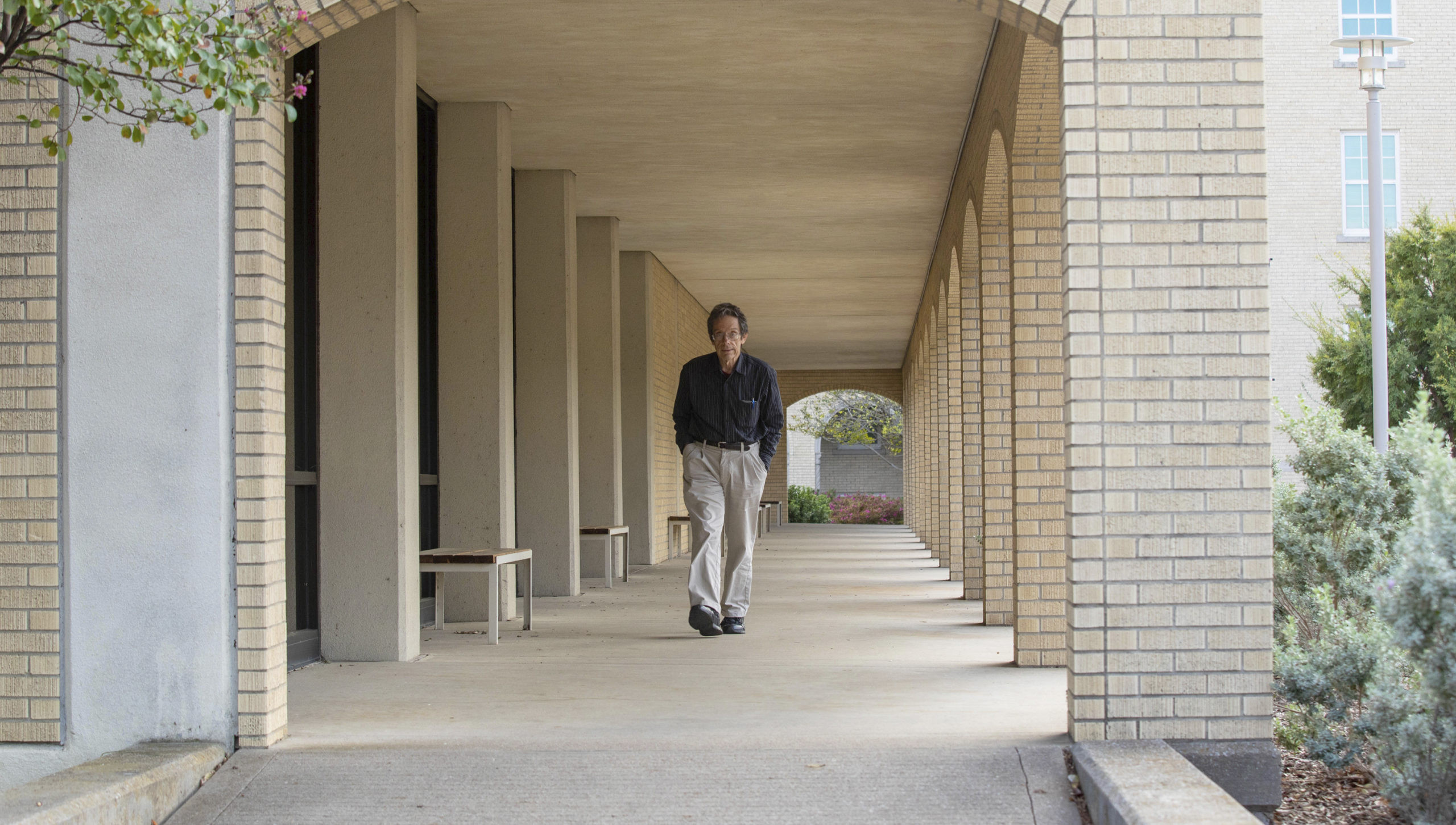 man walking in front of the library