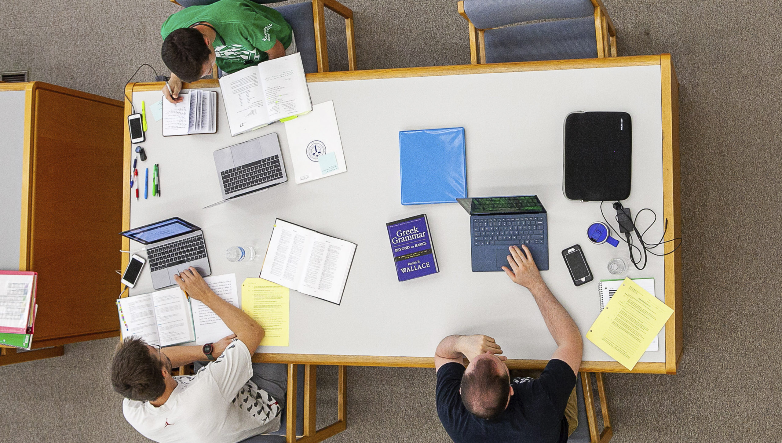 aerial view of three students in the library