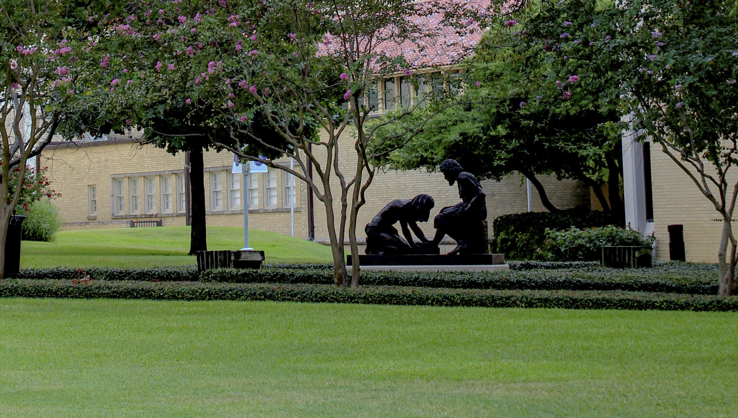 statue of Jesus washing disciples feet in front of Todd Building