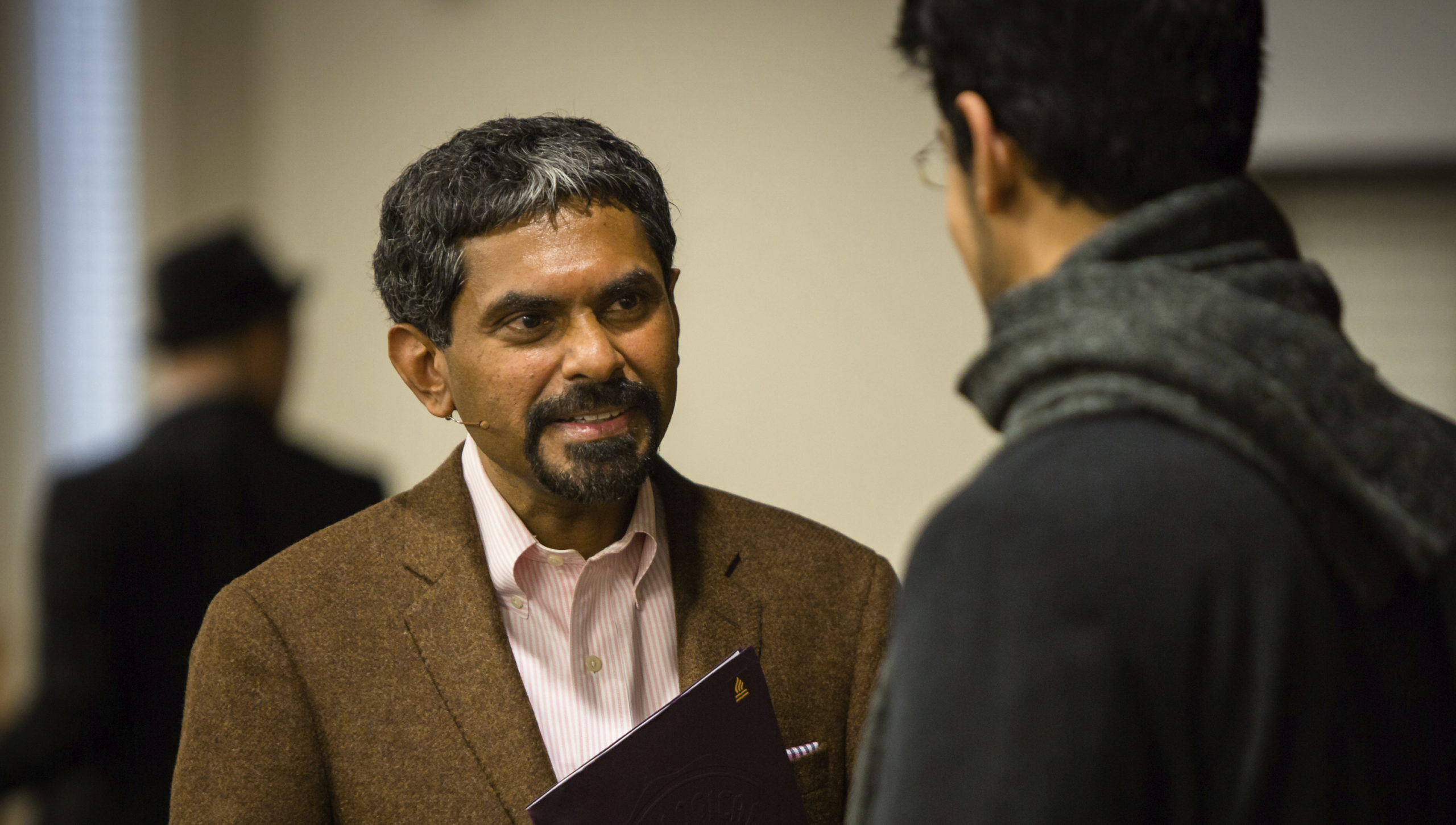 Kuruvilla talking to a student